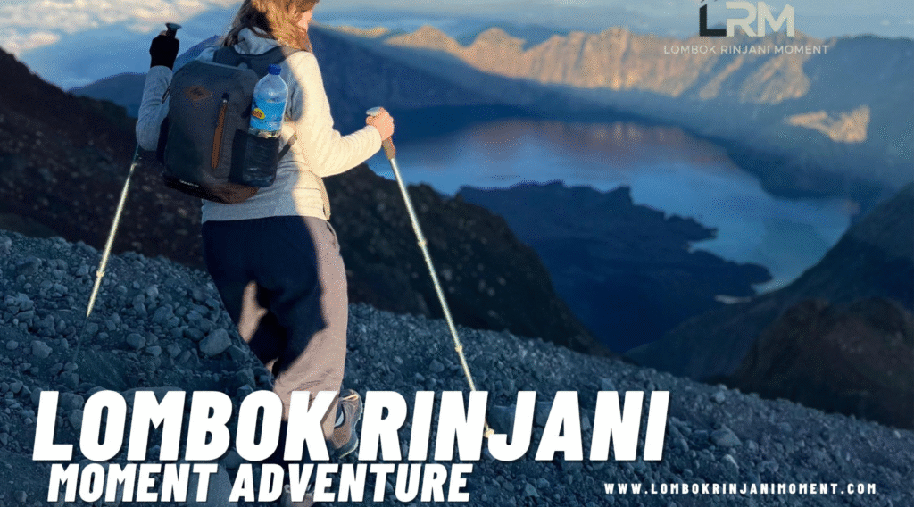 Female hiker with a backpack and trekking poles traversing a rocky slope on Mount Rinjani, overlooking the vast caldera and Segara Anak lake below. The LRM logo is visible in the corner.