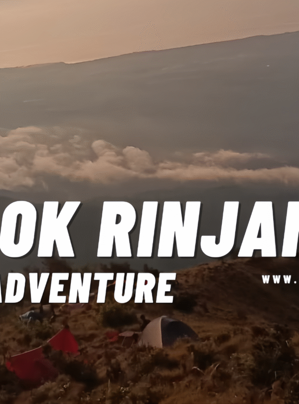 High-altitude campsite view on a steep, rocky ridge of Mount Rinjani during sunrise, with clouds below and the summit ridge visible in the background.
