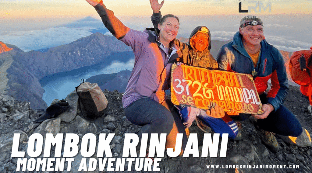 Large group of male and female hikers and guides posing happily at the Rinjani trekking start point with the mountain in the background.