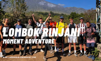 Group of hikers and colorful tents in a Rinjani campsite surrounded by scattered pine trees and dry grass during the evening.